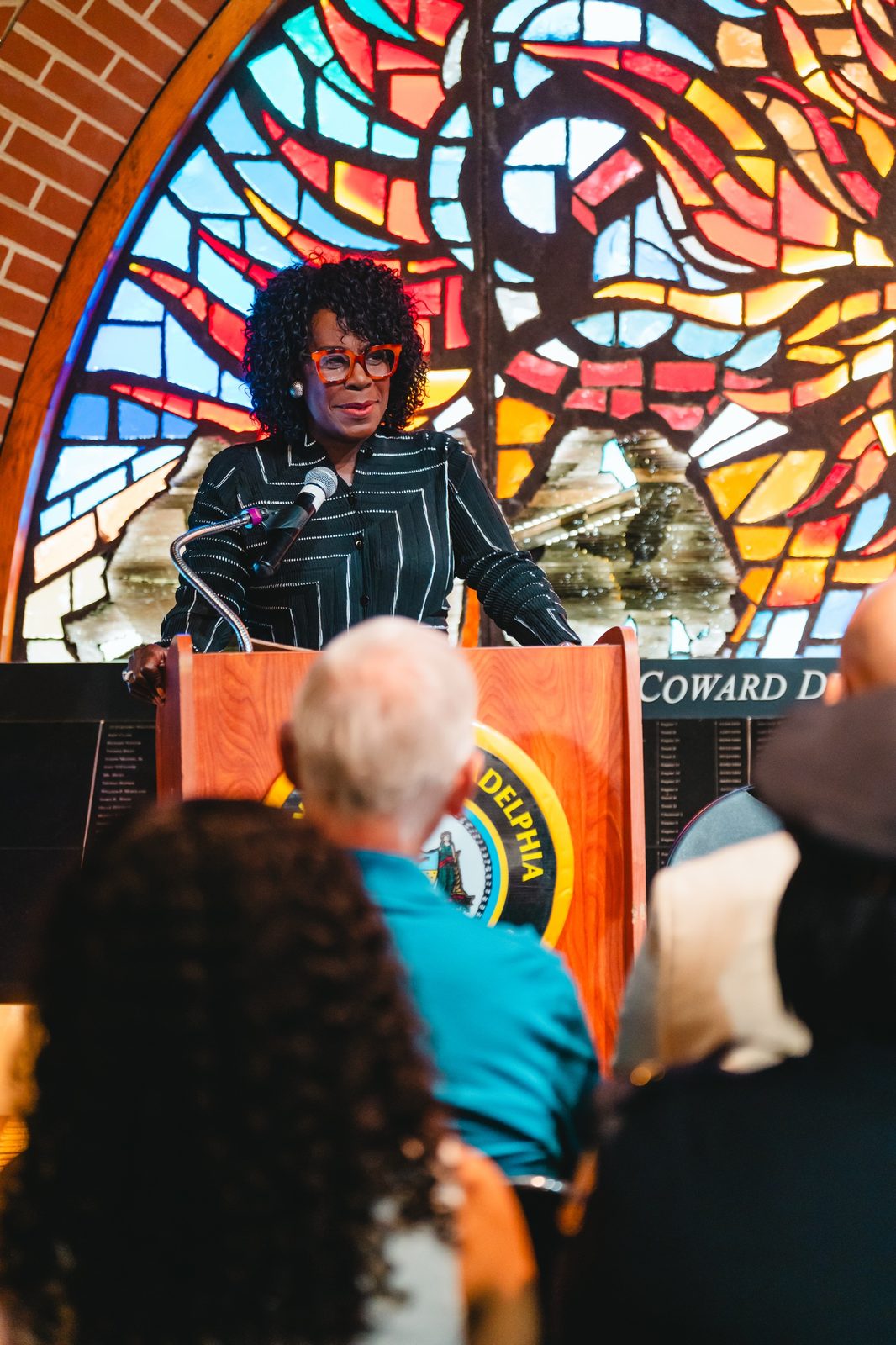 Mayor Cherelle L. Parker speaking in front of a stained-glass window