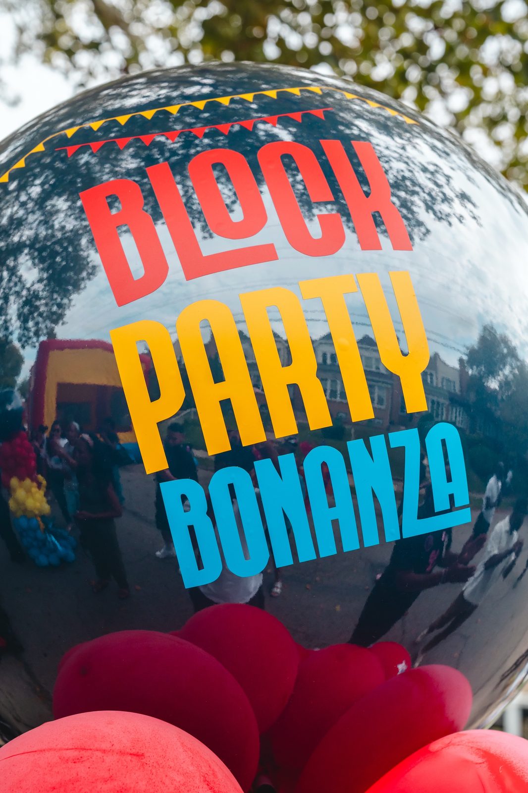 A Block Party Bonanza balloon reflecting the street